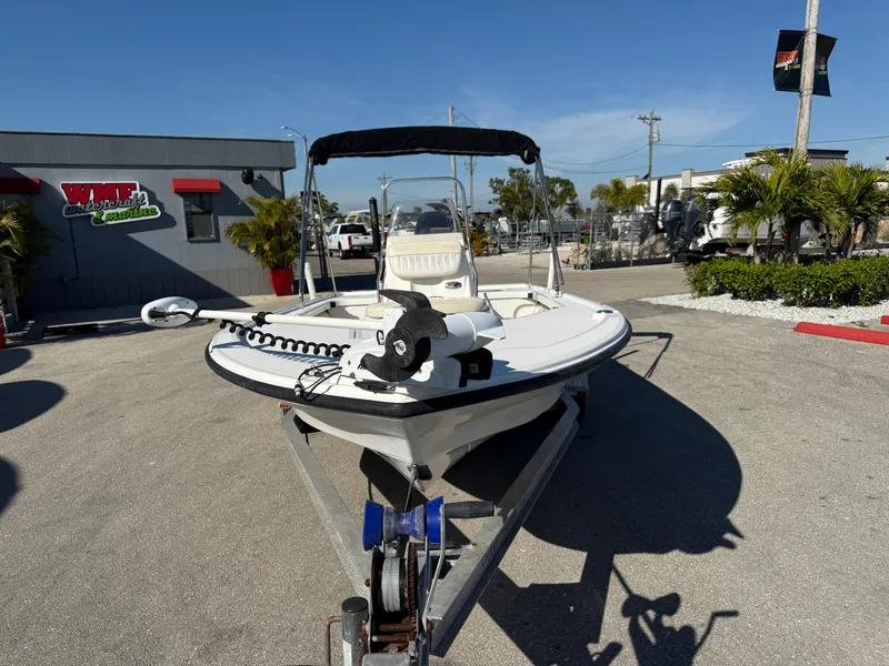 Slide: The Image of 2011 Mako 18 LTS Inshore boat on trailer, parked outdoors under clear sky. - 3