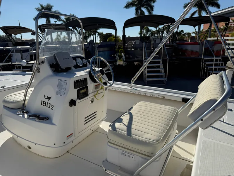 Slide: The Image of 2011 Mako 18 LTS Inshore boat interior with steering console and seating. - 9