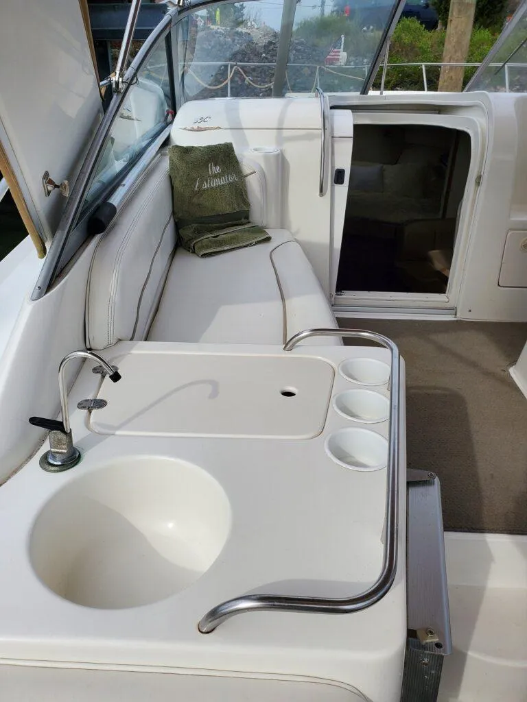 Slide: The Image of Interior of 2000 Larson 330 CABRIO boat with sink and seating area. - 10