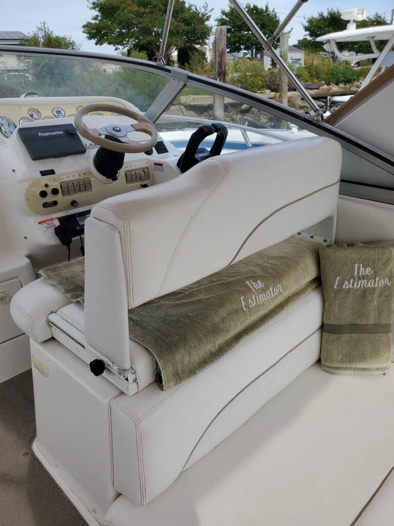 Slide: The Image of Interior of 2000 Larson 330 CABRIO boat with white seating and dashboard controls. - 12