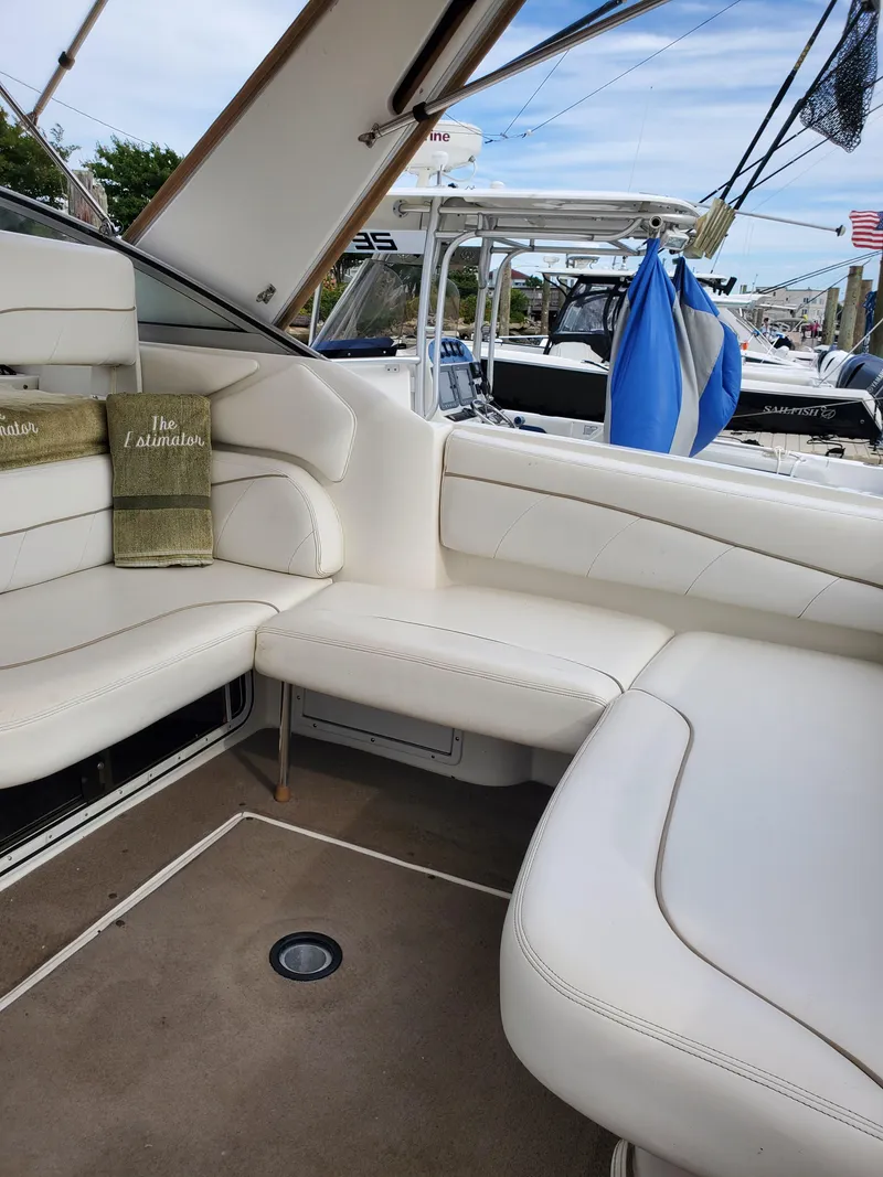 Slide: The Image of Interior of a 2000 Larson 330 CABRIO boat with white seating and nautical decor. - 14