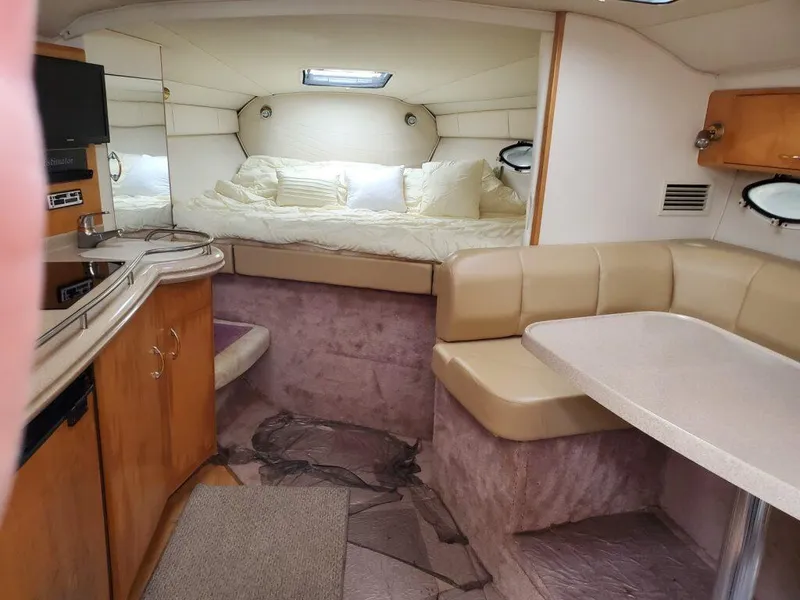 Slide: The Image of Interior of a 2000 Larson 330 CABRIO boat with cozy seating and sleeping area. - 15