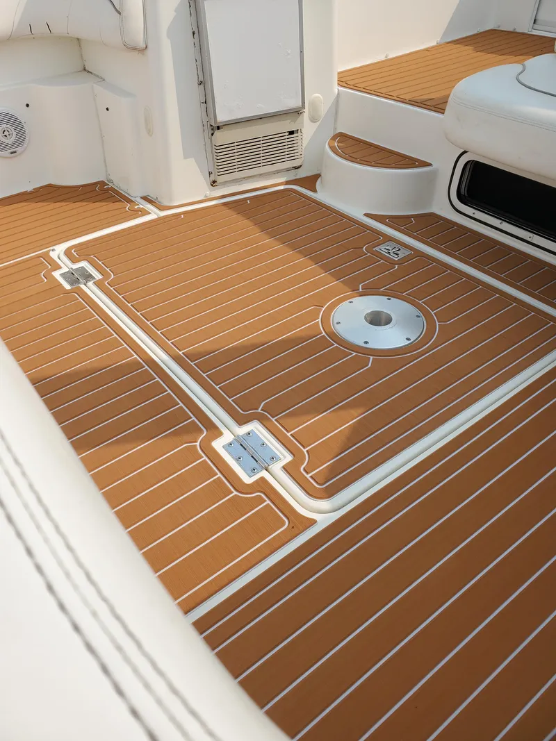 Slide: The Image of Interior view of a 2000 Larson 330 CABRIO boat with teak-style flooring. - 24