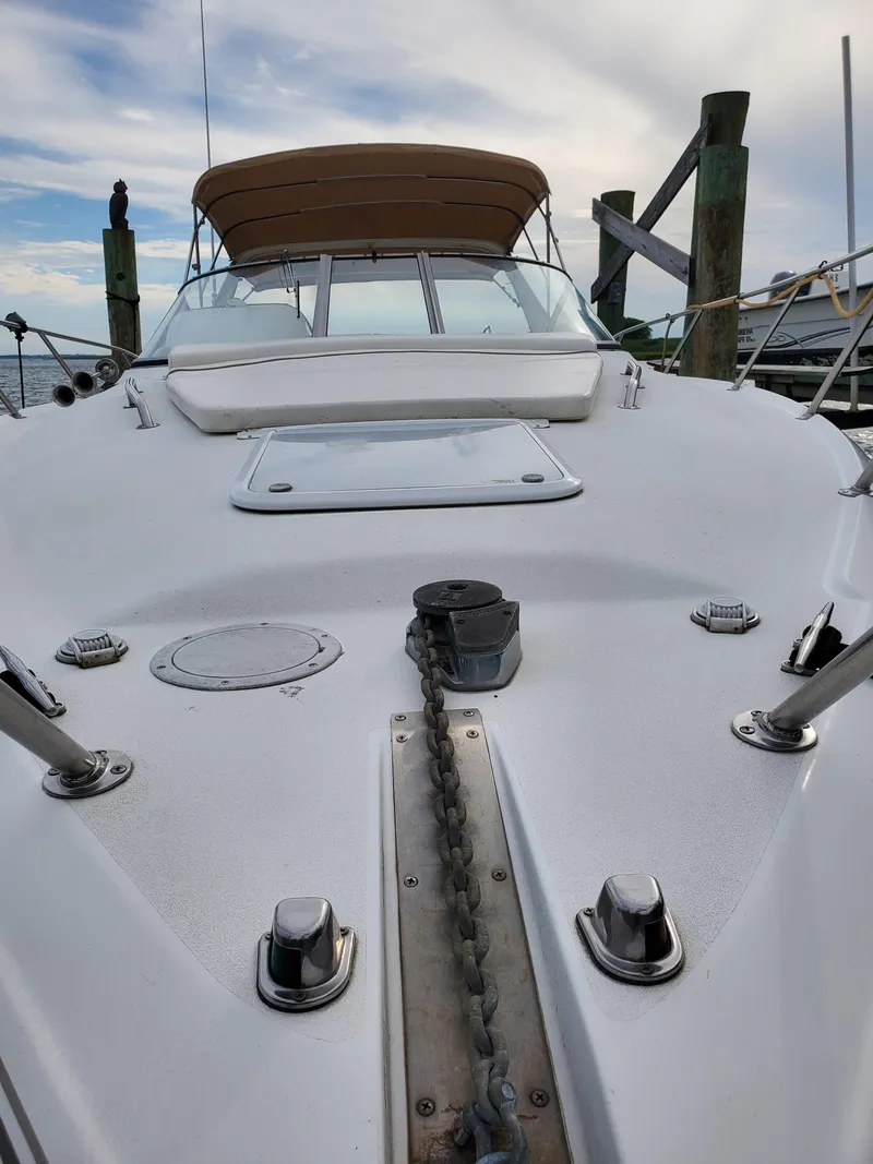 Slide: The Image of 2000 Larson 330 Cabrio boat deck with anchor chain and canopy, docked at marina. - 6