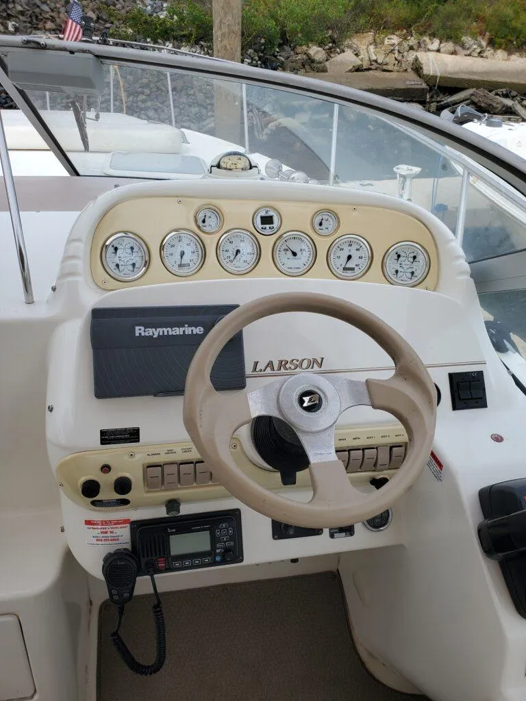 Slide: The Image of Steering console of a 2000 Larson 330 Cabrio boat with gauges and controls. - 7