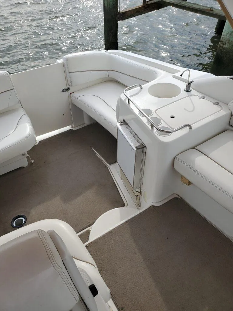 Slide: The Image of Interior of a 2000 Larson 330 CABRIO boat with white seating and a small sink. - 8