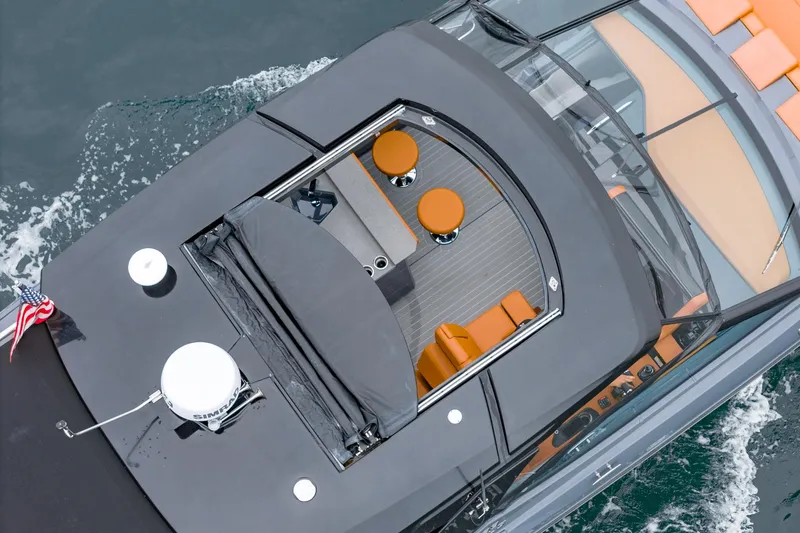 Slide: The Image of 2022 Cruisers Yachts 38 GLS, aerial view, sleek design, luxury seating, cruising on water. - 10