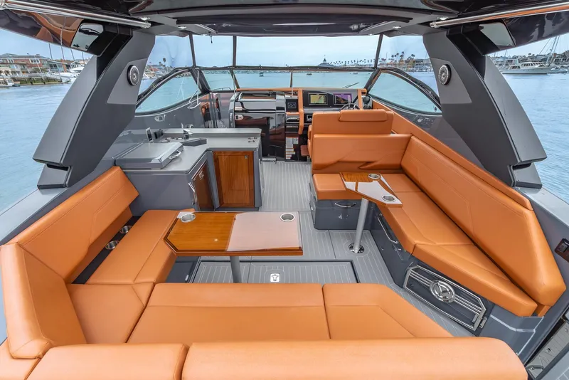 Slide: The Image of Luxurious interior of 2022 Cruisers Yachts 38 GLS with tan seating and modern amenities. - 11