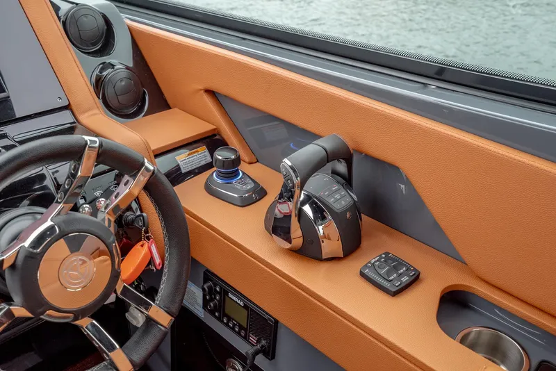 Slide: The Image of 2022 Cruisers Yachts 38 GLS helm with controls and steering wheel, featuring modern design. - 13