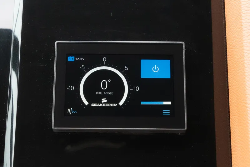 Slide: The Image of Seakeeper control panel on 2022 Cruisers Yachts 38 GLS, displaying roll angle and power status. - 14