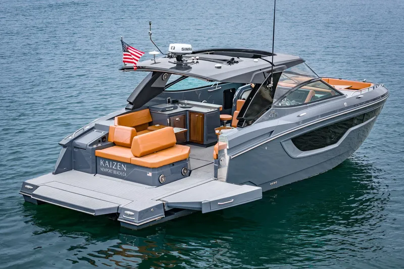 Slide: The Image of 2022 Cruisers Yachts 38 GLS, sleek design, luxury seating, on calm water. - 2