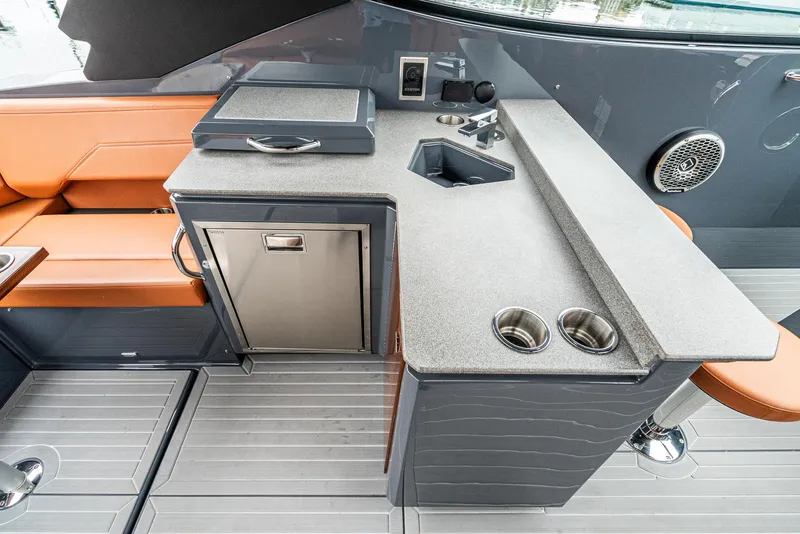 Slide: The Image of 2022 Cruisers Yachts 38 GLS boat interior with kitchenette and seating area. - 20
