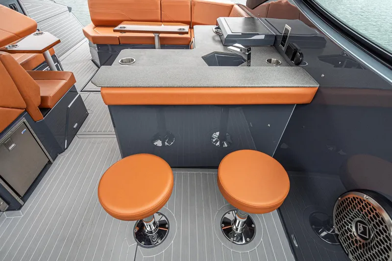 Slide: The Image of 2022 Cruisers Yachts 38 GLS interior with orange seating and modern bar area. - 22