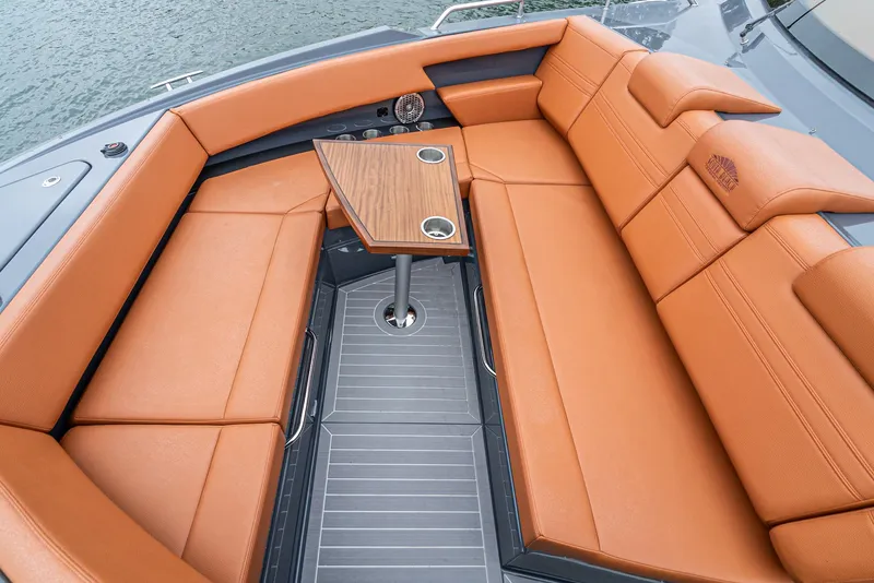 Slide: The Image of 2022 Cruisers Yachts 38 GLS interior with orange seating and wooden table. - 24