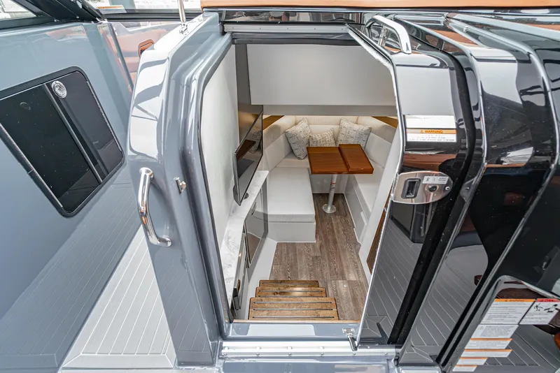 Slide: The Image of 2022 Cruisers Yachts 38 GLS interior with cozy seating and wooden table. - 25