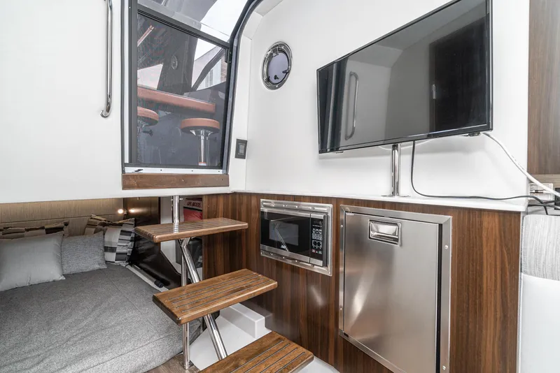 Slide: The Image of Interior of 2022 Cruisers Yachts 38 GLS with TV, microwave, and stairs. - 28