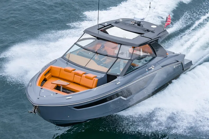 Slide: The Image of 2022 Cruisers Yachts 38 GLS speeding on water, featuring sleek design and orange seating. - 38