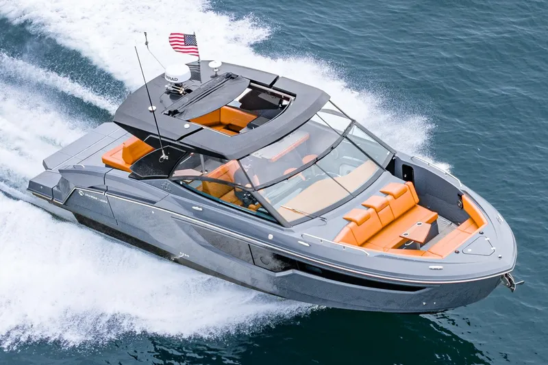 Slide: The Image of 2022 Cruisers Yachts 38 GLS speeding on water, featuring sleek design and orange seating. - 39