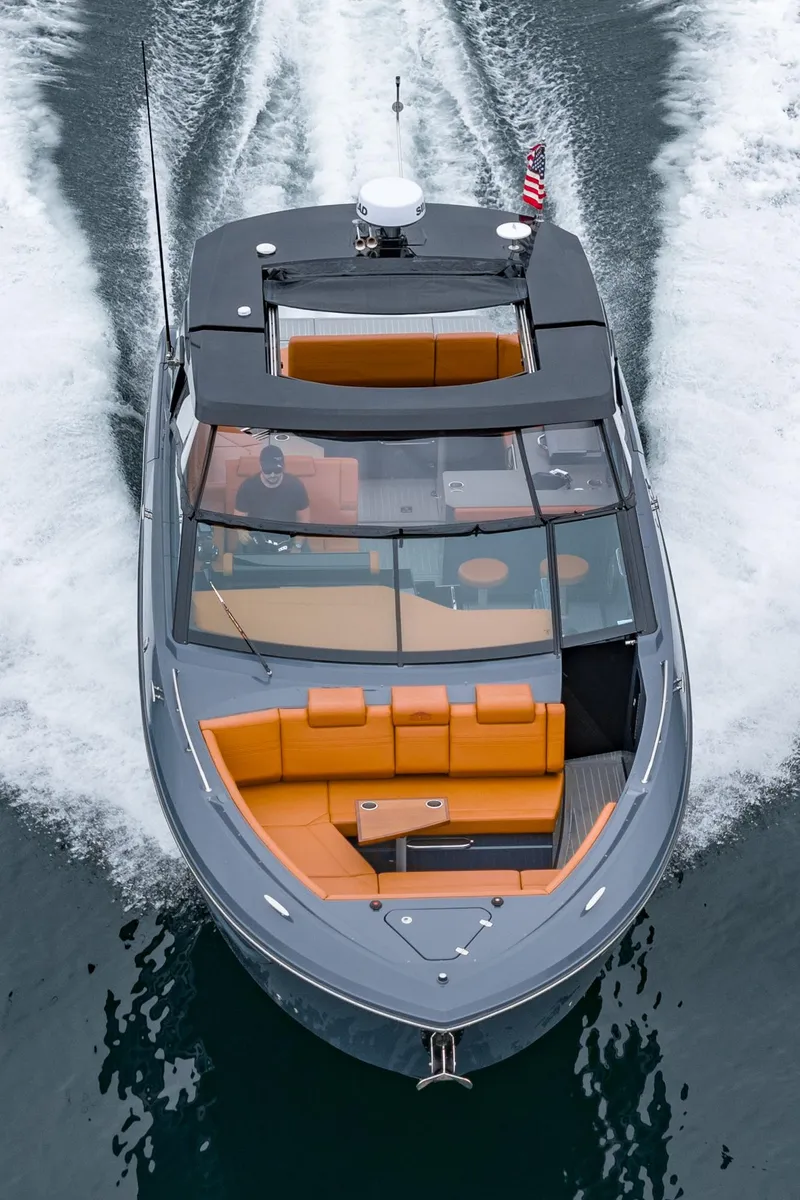Slide: The Image of 2022 Cruisers Yachts 38 GLS, sleek design, cruising on water with orange seating. - 40