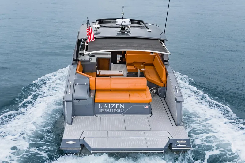 Slide: The Image of 2022 Cruisers Yachts 38 GLS with orange seating, cruising on open water. - 6