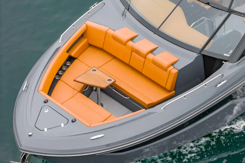 Slide: The Image of 2022 Cruisers Yachts 38 GLS with orange seating and sleek design on water. - 9