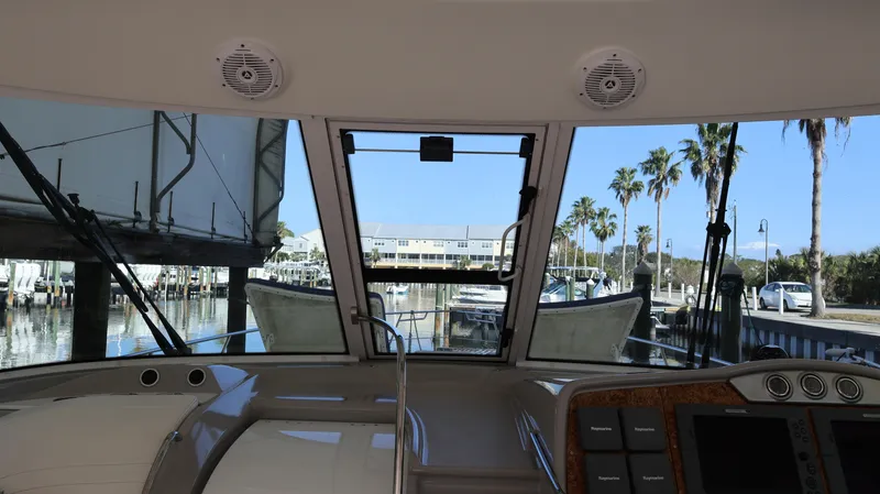 Slide: The Image of Interior view from a 2007 Formula 45 Yacht, overlooking a marina with palm trees. - 14