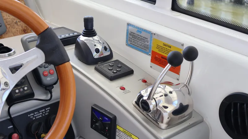 Slide: The Image of Control panel of a 2007 Formula 45 Yacht with steering wheel and throttle levers. - 26