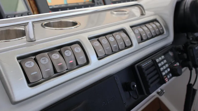Slide: The Image of Control panel of a 2007 Formula 45 Yacht with labeled switches and navigation equipment. - 28
