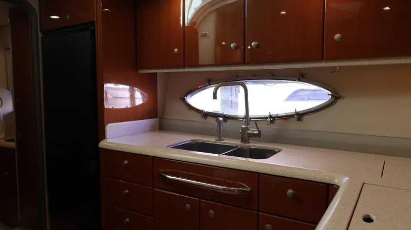 Slide: The Image of Luxurious kitchen interior of 2007 Formula 45 Yacht with wooden cabinets and dual sink. - 45