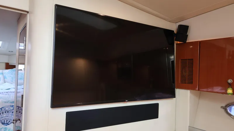 Slide: The Image of Large flat-screen TV inside 2007 Formula 45 Yacht cabin, with wooden cabinetry and modern decor. - 50