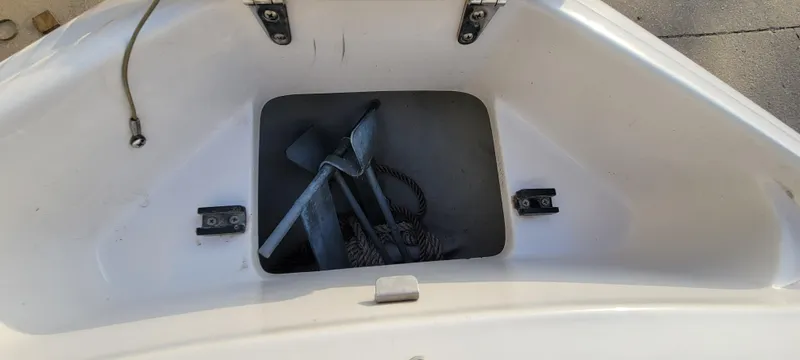 Slide: The Image of Storage compartment of a 1997 Four Winns 200 Horizon boat with anchor and rope. - 11