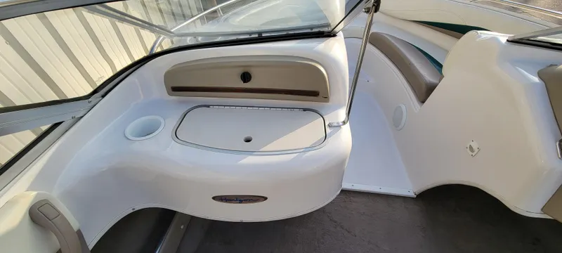 Slide: The Image of 1997 Four Winns 200 Horizon boat interior with steering wheel and white seats. - 14