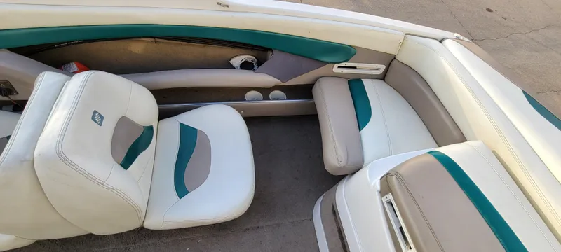 Slide: The Image of 1997 Four Winns 200 Horizon boat interior with beige and teal seating. - 16
