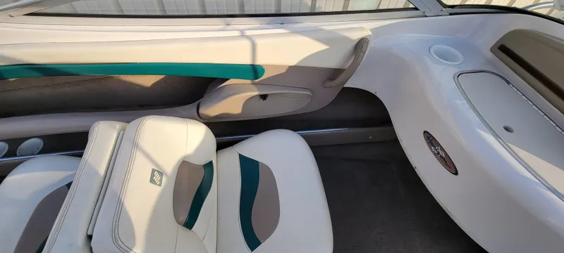 Slide: The Image of Interior view of a 1997 Four Winns 200 Horizon boat, featuring a storage compartment. - 18
