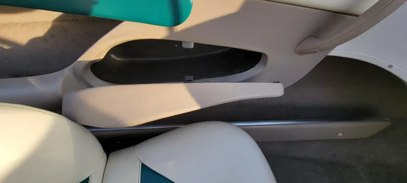 Slide: The Image of Interior of a 1997 Four Winns 200 Horizon boat, featuring beige upholstery. - 21