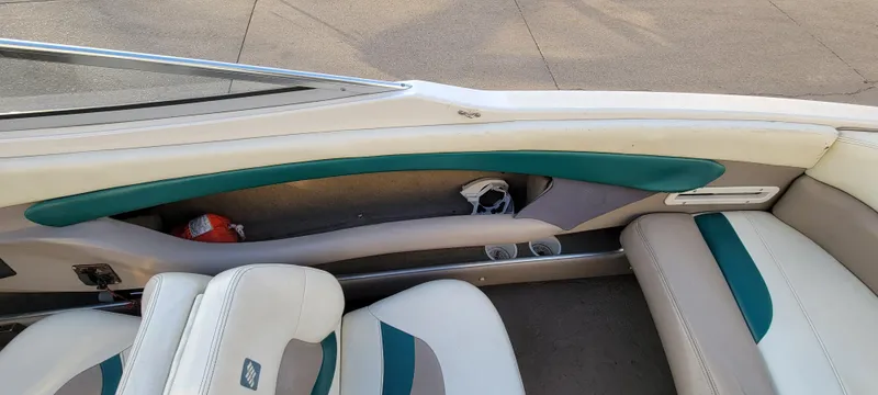 Slide: The Image of 1997 Four Winns 200 Horizon boat on trailer, green and white design, parked on concrete. - 23