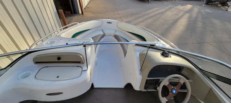 Slide: The Image of 1997 Four Winns 200 Horizon boat interior with steering wheel and seating area. - 6