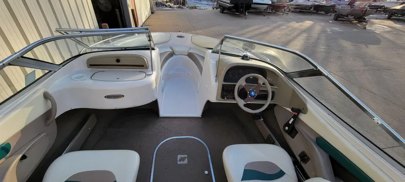 Slide: The Image of 1997 Four Winns 200 Horizon boat interior with steering wheel and seating. - 7