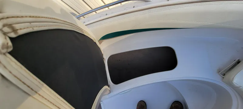 Slide: The Image of Interior view of a 1997 Four Winns 200 Horizon boat, featuring seating and storage area. - 9