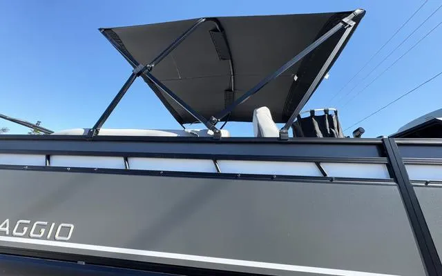 Slide: The Image of 2025 Viaggio Lago X22U boat with canopy, side view under clear sky. - 10