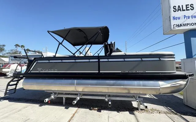 Slide: The Image of 2025 Viaggio Lago X22U pontoon boat with canopy, displayed outdoors. - 11