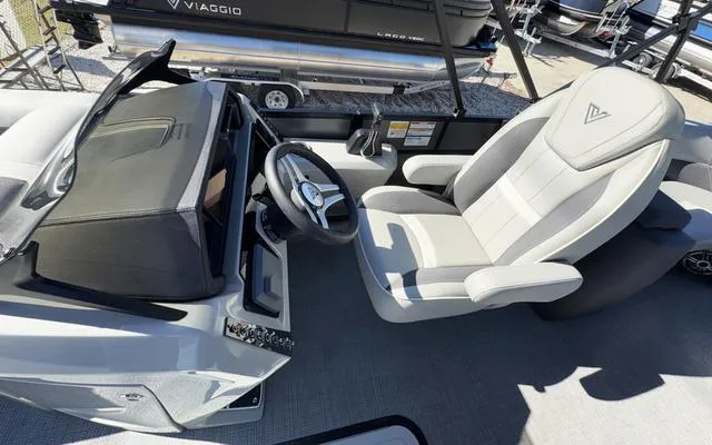 Slide: The Image of 2025 Viaggio Lago X22U boat interior with steering wheel and captain's chair. - 20