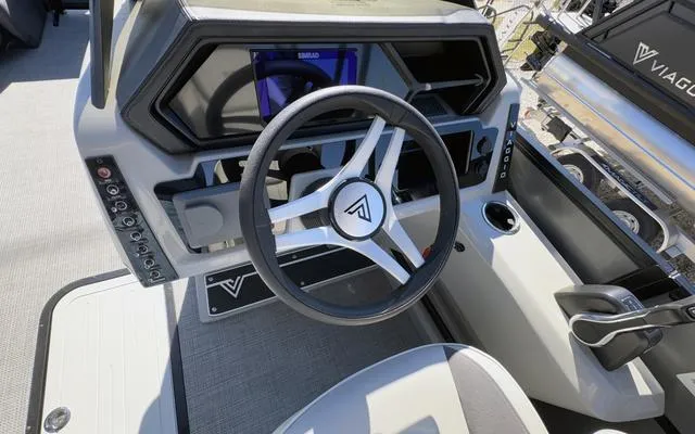 Slide: The Image of 2025 Viaggio Lago X22U boat dashboard with modern steering wheel and controls. - 25