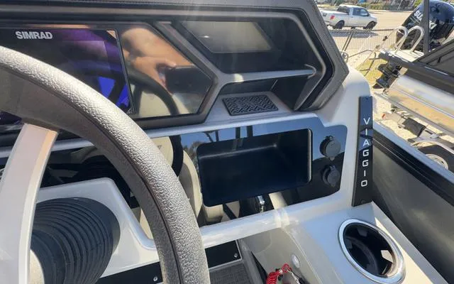 Slide: The Image of Interior dashboard of 2025 Viaggio Lago X22U boat with modern controls and display. - 28