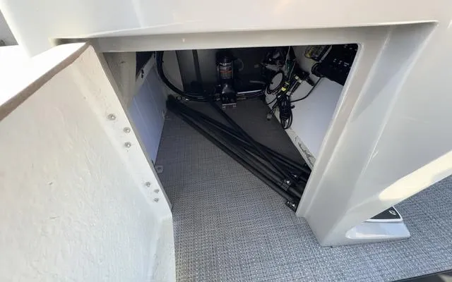 Slide: The Image of Storage compartment of 2025 Viaggio Lago X22U boat, showing interior equipment and wiring. - 29
