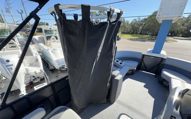 Slide: The Image of 2025 Viaggio Lago X22U boat interior with privacy curtain and seating area. - 31