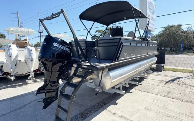 Slide: The Image of 2025 Viaggio Lago X22U pontoon boat with Suzuki outboard motor, parked outdoors. - 4