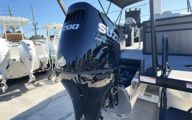 Slide: The Image of 2025 Viaggio Lago X22U with Suzuki 200 outboard motor, displayed outdoors. - 6