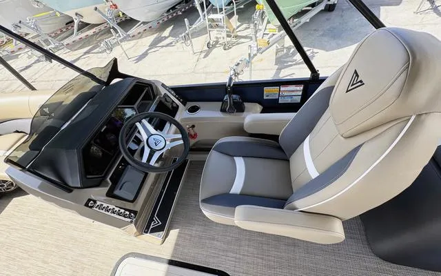 Slide: The Image of 2025 Viaggio Lago X 22 U boat interior with steering wheel and captain's chair. - 19