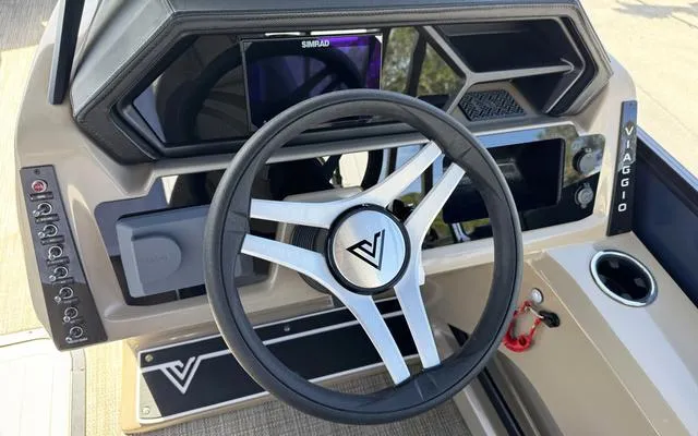 Slide: The Image of 2025 Viaggio Lago X 22 U boat dashboard with steering wheel and control panel. - 20